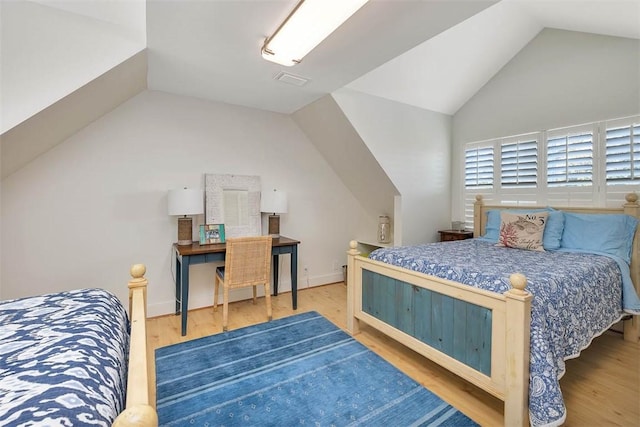 bedroom featuring lofted ceiling and wood finished floors