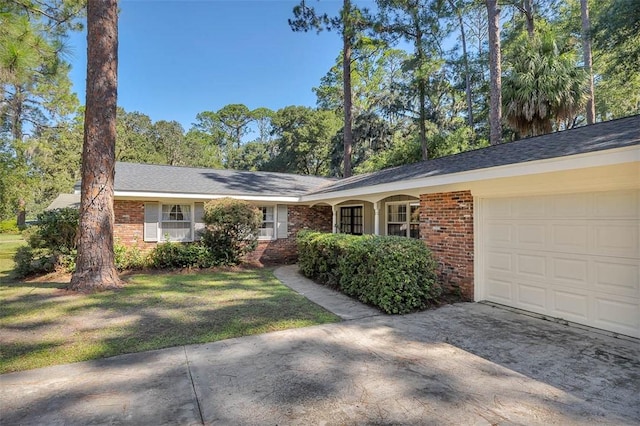 ranch-style house with a garage and a front lawn