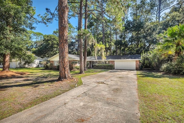 ranch-style house featuring a garage and a front yard