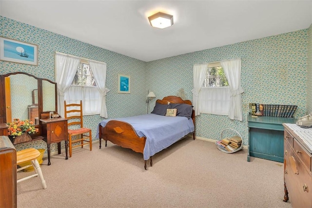 bedroom featuring light carpet and multiple windows