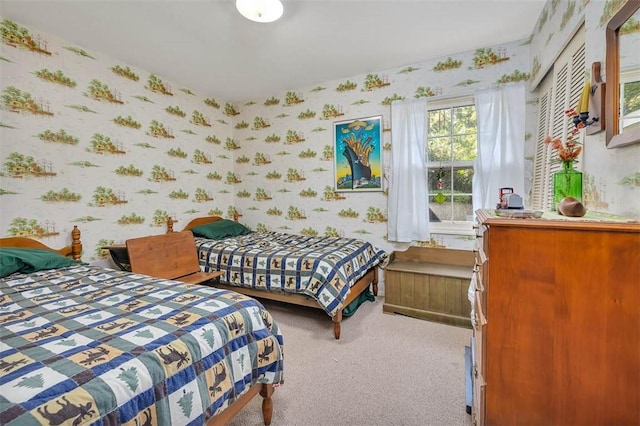 bedroom featuring light carpet and a closet