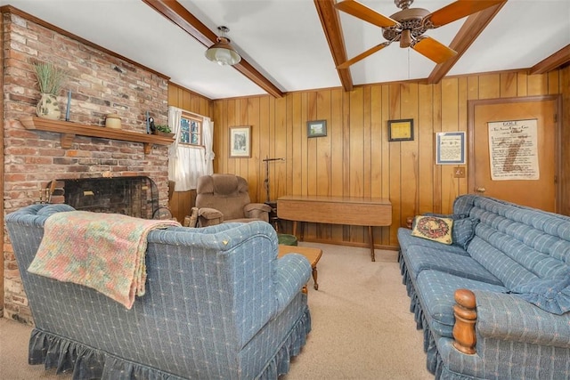 753 N Riverview Dr, Jekyll Island, GA 31527 - carpeted living room featuring ceiling fan, beam ceiling, wooden walls, and a brick fireplace