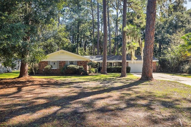 ranch-style house featuring a front yard and a garage