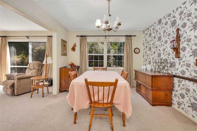 753 N Riverview Dr, Jekyll Island, GA 31527 - dining space featuring light carpet and an inviting chandelier