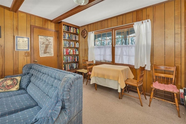 753 N Riverview Dr, Jekyll Island, GA 31527 - living area with beam ceiling, light colored carpet, and wooden walls