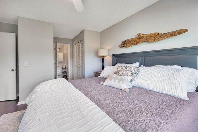 bedroom featuring wood-type flooring, connected bathroom, a closet, and ceiling fan