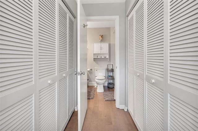 corridor with hardwood / wood-style floors