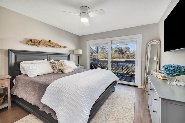 bedroom featuring ceiling fan, wood-type flooring, and access to outside