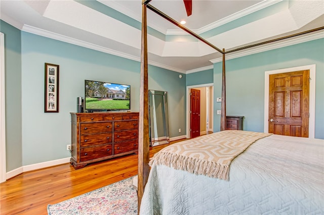 bedroom with recessed lighting, wood finished floors, baseboards, ornamental molding, and a raised ceiling