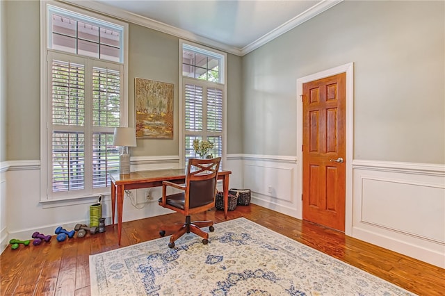 home office with a wainscoted wall, ornamental molding, and wood finished floors