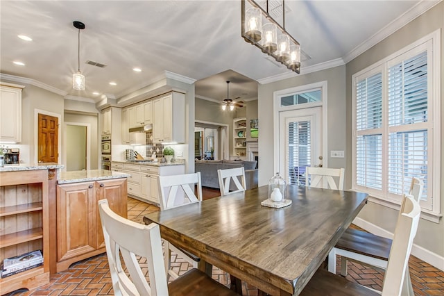 dining space with brick floor, baseboards, visible vents, and ornamental molding