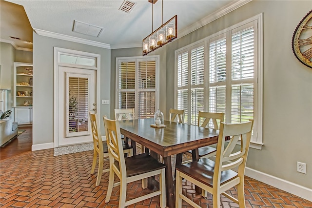 dining area with brick floor, visible vents, crown molding, and baseboards