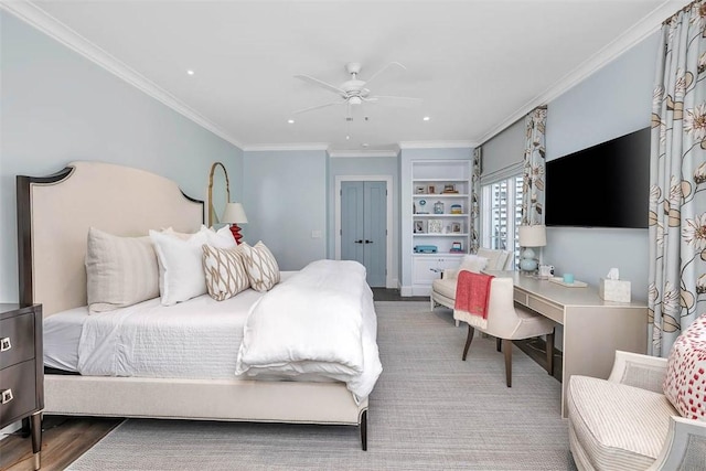 bedroom featuring ceiling fan, crown molding, and hardwood / wood-style flooring