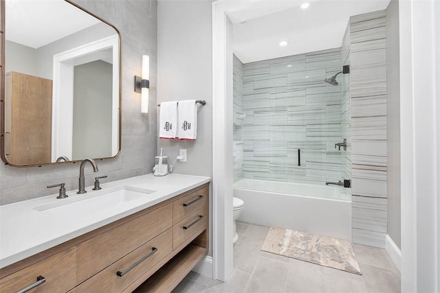 full bathroom featuring tile patterned flooring, vanity, toilet, and tiled shower / bath