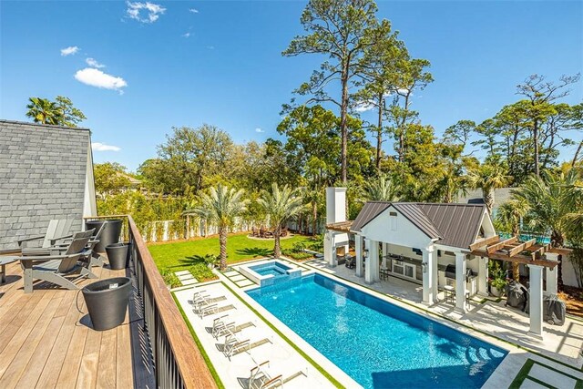 view of swimming pool with an in ground hot tub and a deck