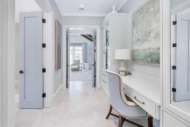 office space featuring built in desk and ornamental molding