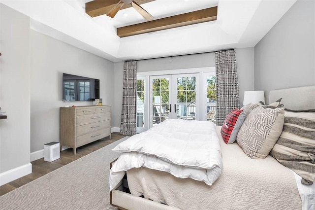 bedroom featuring access to exterior, french doors, dark hardwood / wood-style flooring, a raised ceiling, and ceiling fan