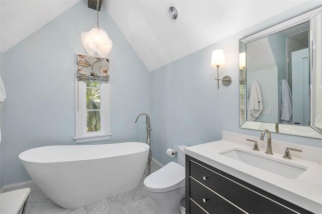 bathroom with a tub to relax in, vanity, vaulted ceiling, and toilet