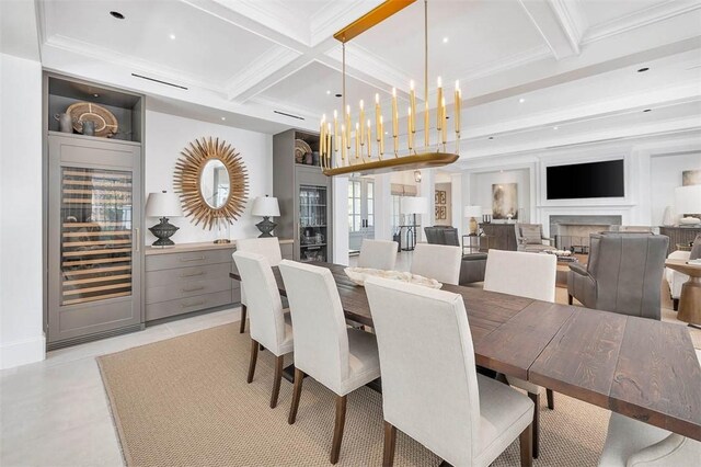 dining space with beamed ceiling, light tile patterned flooring, ornamental molding, and coffered ceiling