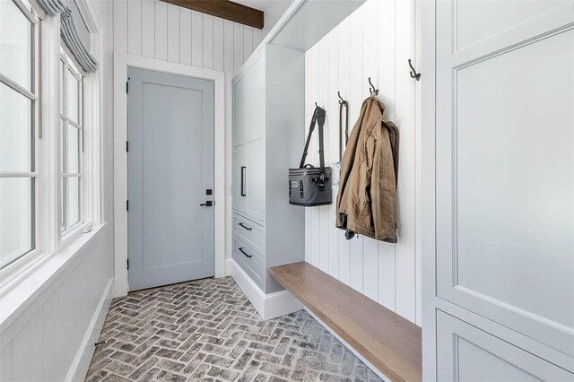 mudroom with wooden walls