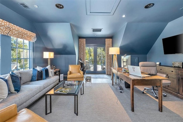 carpeted office with plenty of natural light, lofted ceiling, and french doors