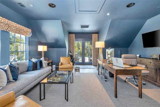 carpeted office with plenty of natural light, lofted ceiling, and french doors