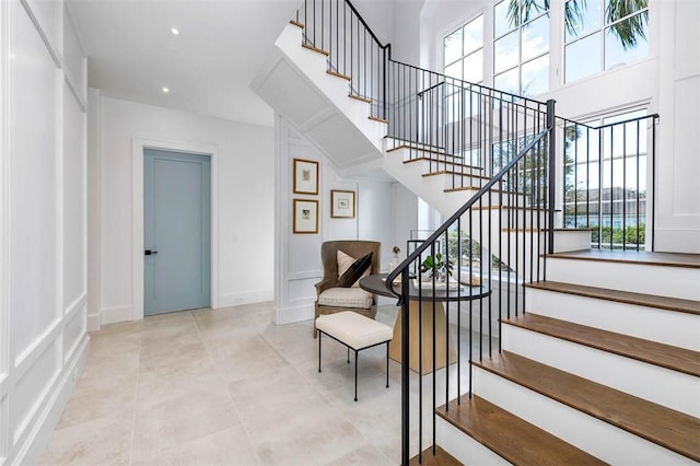 stairway featuring tile patterned floors and a wealth of natural light