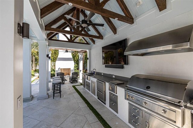 view of patio featuring sink, an outdoor kitchen, ceiling fan, and a grill