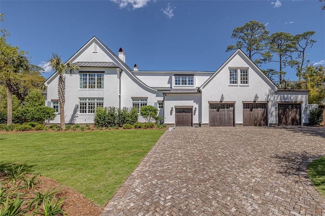 view of front of home featuring a front lawn and a garage