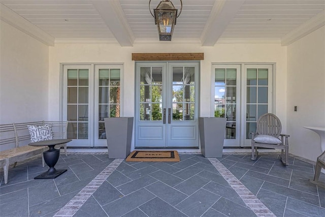 view of exterior entry featuring a patio area and french doors