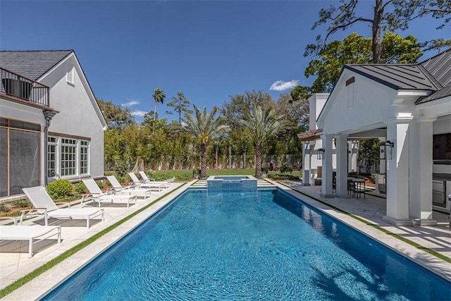 view of swimming pool with an in ground hot tub and a patio