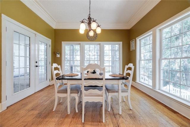1151 W Mission Ln SE, Darien, GA 31305 - dining area with a chandelier, light wood-style flooring, crown molding, baseboards, and french doors