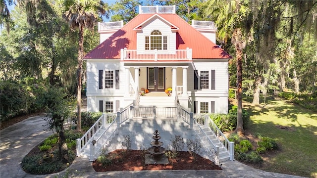 1151 W Mission Ln SE, Darien, GA 31305 - view of front of property featuring stairway, a balcony, french doors, a front yard, and a porch