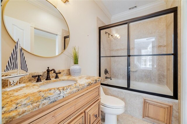 1151 W Mission Ln SE, Darien, GA 31305 - bathroom featuring toilet, vanity, shower / bath combination with glass door, and crown molding