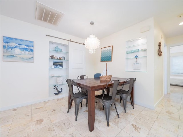 900 Mallory St, Saint Simons Island, GA 31522 - dining room with built in features, a chandelier, and baseboards