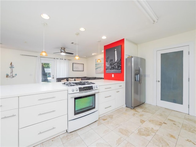 900 Mallory St, Saint Simons Island, GA 31522 - kitchen featuring stainless steel refrigerator with ice dispenser, range with gas stovetop, light countertops, white cabinetry, and a ceiling fan
