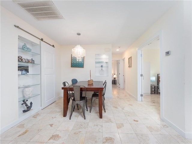 900 Mallory St, Saint Simons Island, GA 31522 - dining area with a barn door, a chandelier, baseboards, light tile patterned floors, and built in features
