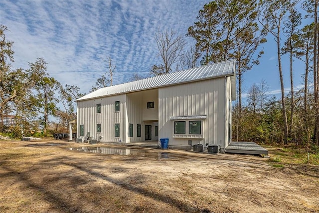 rear view of house featuring cooling unit