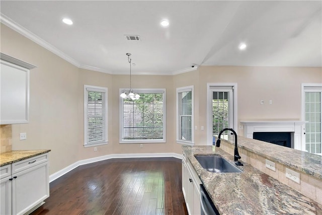 168 Township Bluff Cir, Saint Simons Island, GA 31522 - kitchen featuring white cabinets, sink, hanging light fixtures, light stone countertops, and dark hardwood / wood-style flooring