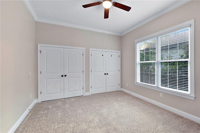 168 Township Bluff Cir, Saint Simons Island, GA 31522 - unfurnished bedroom with multiple closets, ceiling fan, and carpet floors