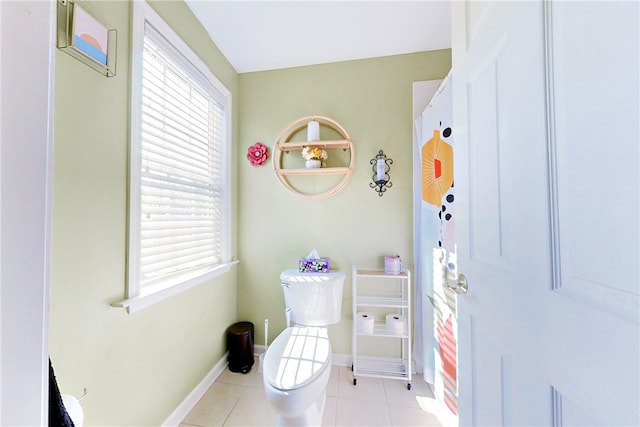 bathroom with toilet and tile patterned floors