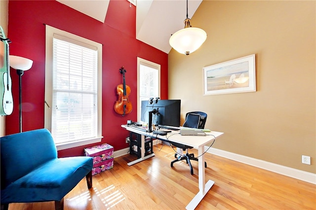 home office featuring hardwood / wood-style flooring and vaulted ceiling