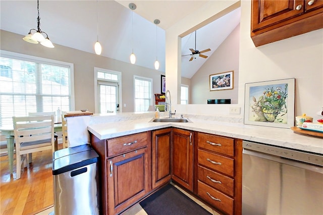 163 N Cottages Dr, Saint Simons Island, GA 31522 - kitchen with dishwasher, vaulted ceiling, brown cabinetry, a ceiling fan, and dark wood finished floors