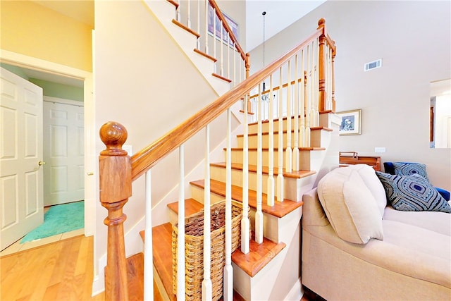 163 N Cottages Dr, Saint Simons Island, GA 31522 - staircase with wood finished floors and a high ceiling