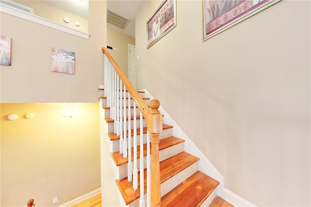 stairs featuring hardwood / wood-style flooring