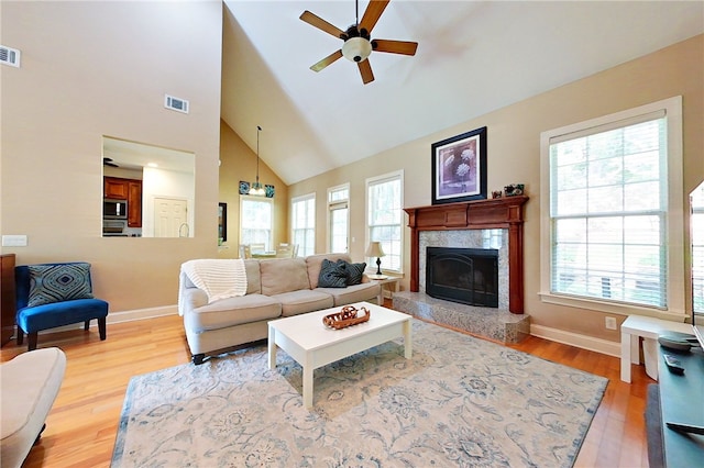 163 N Cottages Dr, Saint Simons Island, GA 31522 - living area featuring high vaulted ceiling, a ceiling fan, healthy amount of natural light, light wood-type flooring, and a fireplace