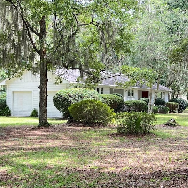 ranch-style home with an attached garage and a front yard