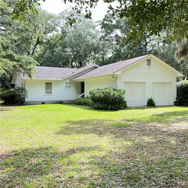 ranch-style house featuring a garage, driveway, crawl space, and a front yard