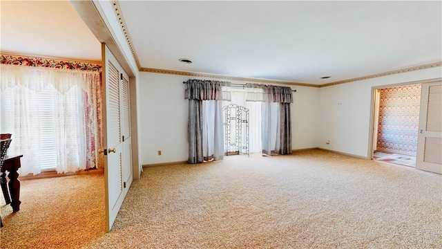 interior space with light colored carpet and ornamental molding