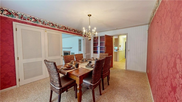 dining area featuring an inviting chandelier and crown molding